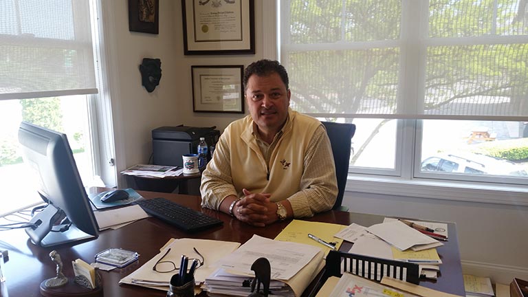 portrait of George M. Nikolaou in his office